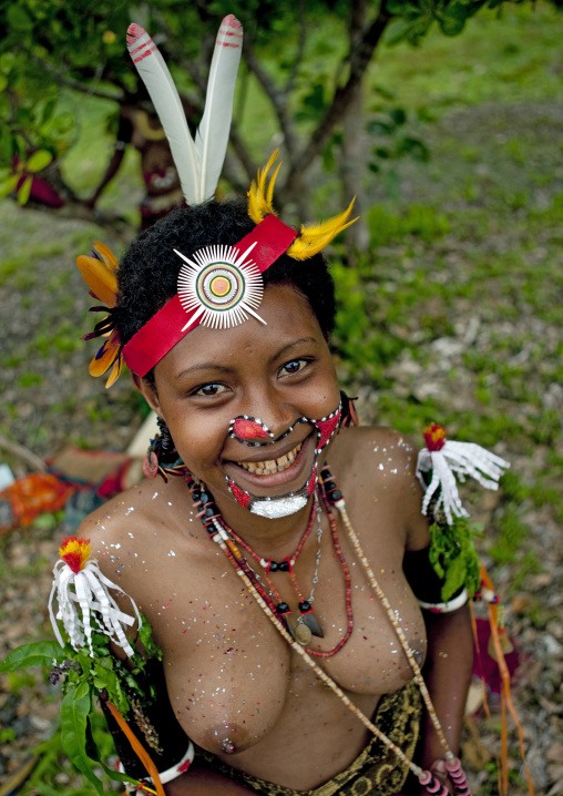 Portrait of a smiling topless tribal woman in traditional clothing, Milne Bay Province, Trobriand Island, Papua New Guinea