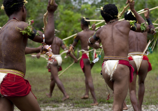Tribal dancers in traditional clothing during a ceremony, Milne Bay Province, Trobriand Island, Papua New Guinea