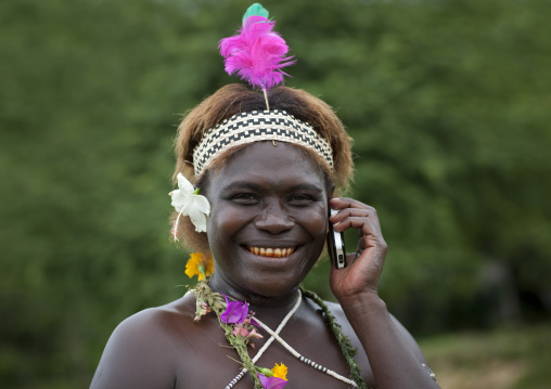 Portrait of a woman in traditional clothes calling on the phone, Autonomous Region of Bougainville, Bougainville, Papua New Guinea