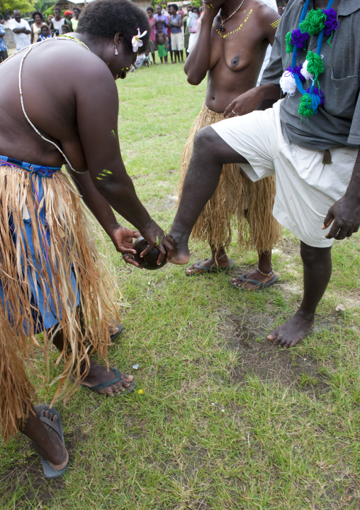 Woman welcoming visitors by washing their feet, Autonomous Region of Bougainville, Bougainville, Papua New Guinea