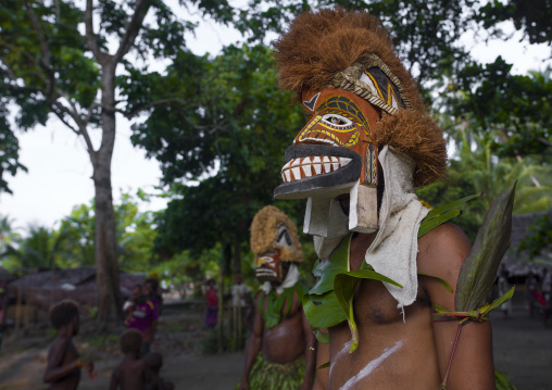 Malagan tatuana masks dance during a funeral ceremony, New Ireland Province, Langania, Papua New Guinea