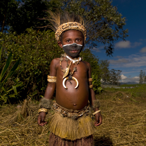 Chimbu tribe boy with a feathers headwear during a Sing-sing ceremony, Western Highlands Province, Mount Hagen, Papua New Guinea