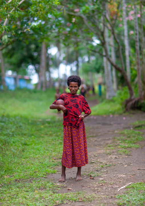 Portrait of a girl in a field, Milne Bay Province, Trobriand Island, Papua New Guinea
