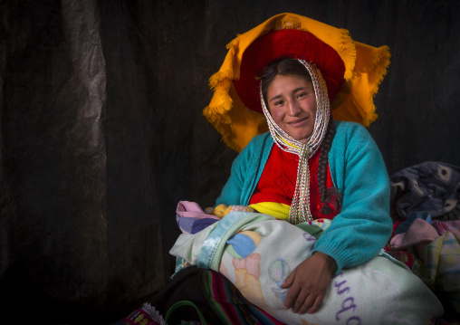 Woman In Traditional Clothing With Her Baby, Qoyllur Riti Festival, Ocongate Cuzco, Peru