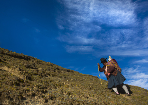 Peruvian Woman Climbing To The Qoyllur Riti Festival, Ocongate Cuzco, Peru
