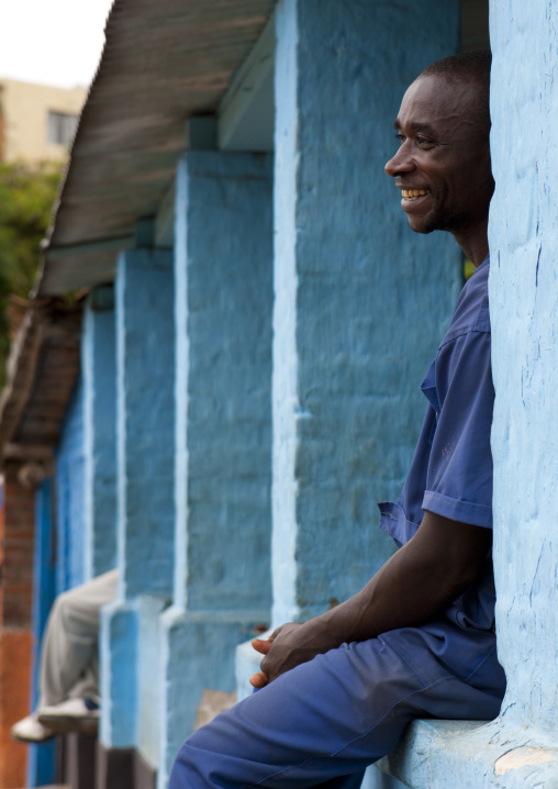 Rwandan man sit on a house balcony, Western Province, Karongi, Rwanda