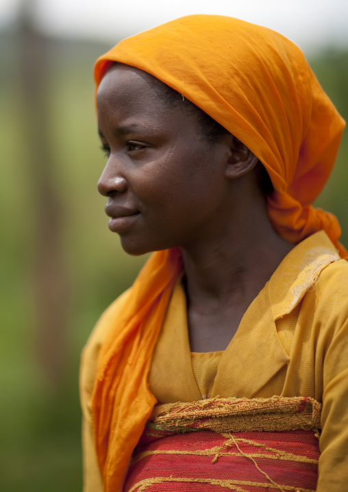 Rwandan woman in ornage clothes, Lake Kivu, Nkombo, Rwanda