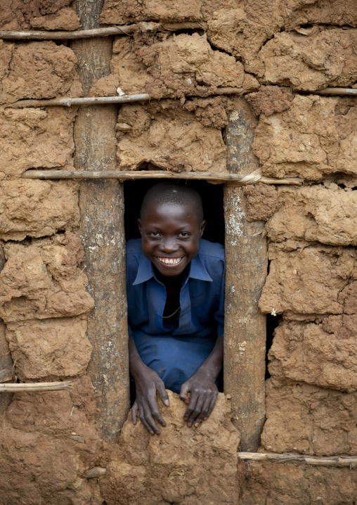 Batwa tribe boy looking though a window, Western Province, Cyamudongo, Rwanda