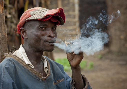 Batwa tribe man smoking, Western Province, Cyamudongo, Rwanda