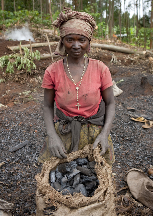 Rwandan woman selling coal, Western Province, Cyamudongo, Rwanda
