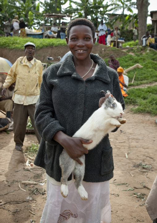 Rwandan woman selling a rabbit in a market, Kigali Province, Kigali, Rwanda