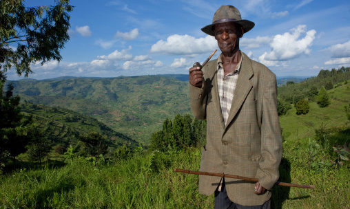 Rwandan old man smoking pipe, Kigali Province, Kigali, Rwanda