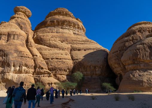 Tourists in al-Diwan in jebel Ithlib, Al Madinah Province, Alula, Saudi Arabia