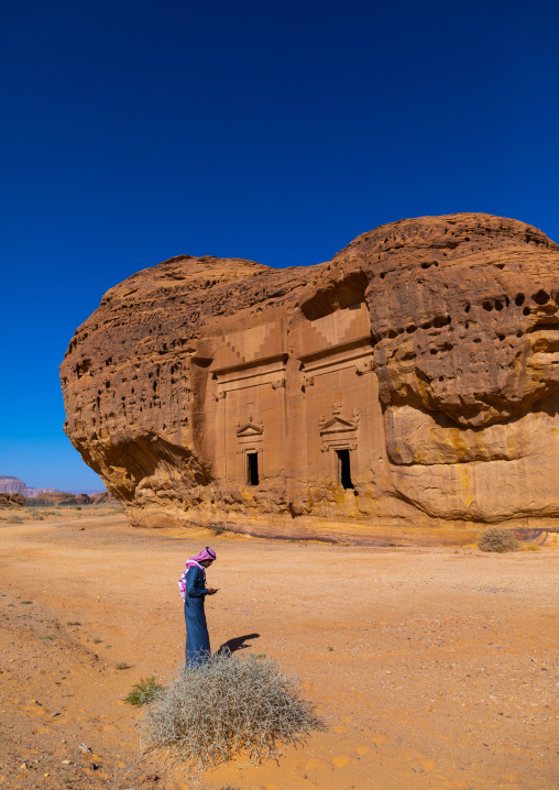 Saudi tourist in front of tombs in al-Hijr archaeological site in Madain Saleh, Al Madinah Province, Alula, Saudi Arabia