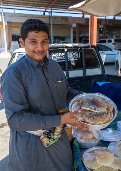 Saudi man selling honeycombs and honey in a market, Asir province, Rijal Alma, Saudi Arabia