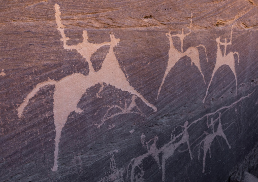 Petroglyphs on a rock depicting men hunting on horses, Najran Province, Minshaf, Saudi Arabia