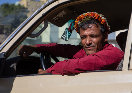 Portrait of a flower man wearing a floral crown on the head in his car, Jizan Province, Addayer, Saudi Arabia