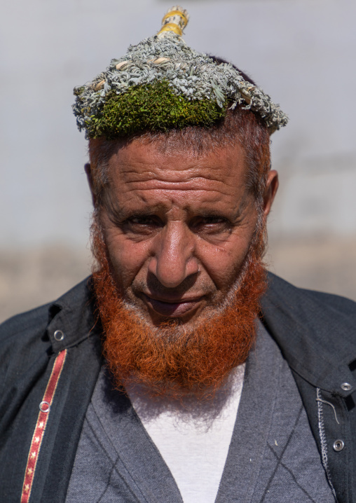 Portrait of a flower man with a red beard wearing a floral crown on the head, Jizan Province, Addayer, Saudi Arabia