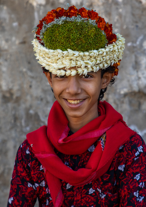 Portrait of a smiling flower boy wearing a floral crown on the head, Jizan Province, Addayer, Saudi Arabia