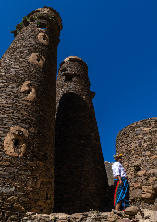 Portrait of a flower man wearing a floral crown on the head near a stone watchtower, Jizan Province, Addayer, Saudi Arabia