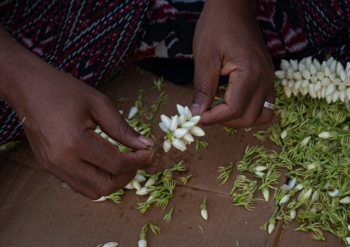 A flower vendor preparing floral garlands and crowns on a market, Jizan Province, Sabya, Saudi Arabia