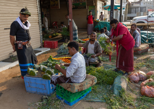 A flower vendor preparing and selling floral garlands and crowns on a market, Jizan Province, Mahalah, Saudi Arabia