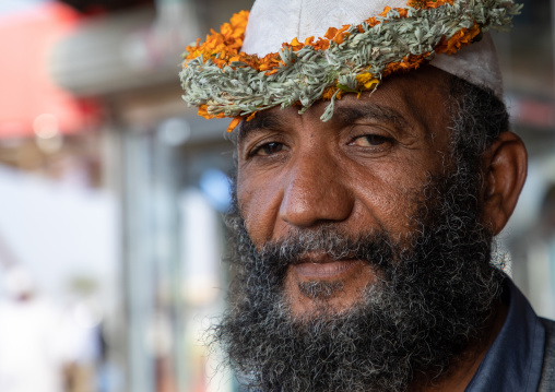 Portrait of a flower man wearing a floral crown on the head, Jizan Province, Mahalah, Saudi Arabia
