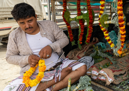 A flower vendor preparing floral garlands and crowns on a market, Jizan Province, Addayer, Saudi Arabia