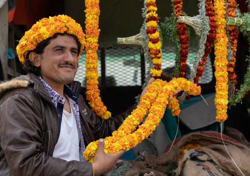 A flower vendor preparing floral garlands and crowns on a market, Jizan Province, Addayer, Saudi Arabia