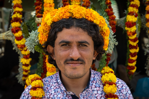 A flower vendor with floral garlands and crowns on a market, Jizan Province, Addayer, Saudi Arabia