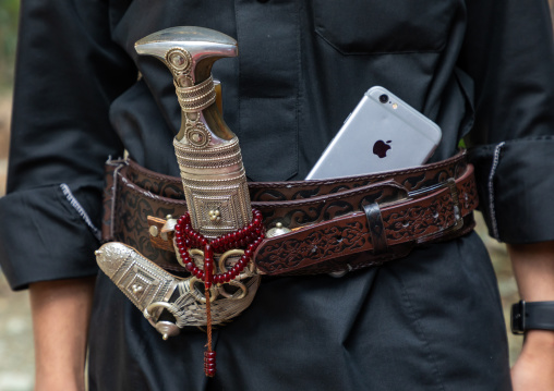 Saudi man with an iphone and a janbiya in his belt, Jizan Province, Jebel Qahar, Saudi Arabia