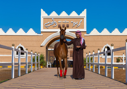 saudi man with his Arabian horse in Alhazm stud, Najran Province, Khubash, Saudi Arabia