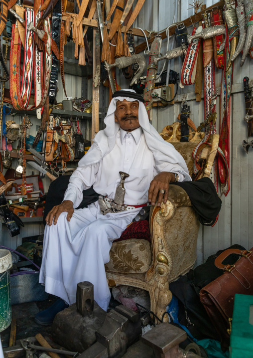 Old saudi man selling belts and  janbiya daggers, Asir province, Abha, Saudi Arabia