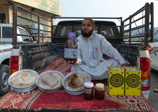 Saudi man selling honey and honeycombs on a market, Asir province, Al Habeel, Saudi Arabia