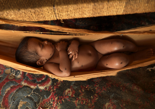 Yemeni baby sleeping in a hammock, Jizan Province, Jizan, Saudi Arabia