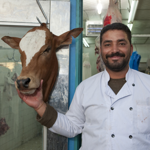Butcher with a cow head, Asir province, Sarat Abidah, Saudi Arabia