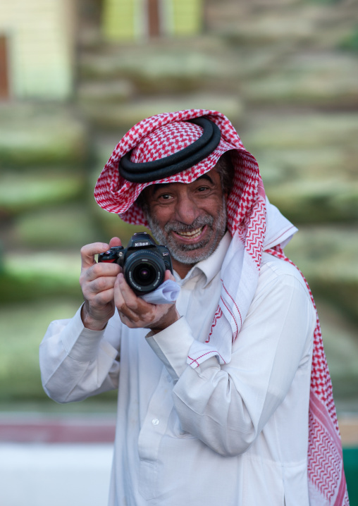 Portrait of a saudi man wearing a kaffiyeh taking pictures, Al-Jawf Province, Sakaka, Saudi Arabia
