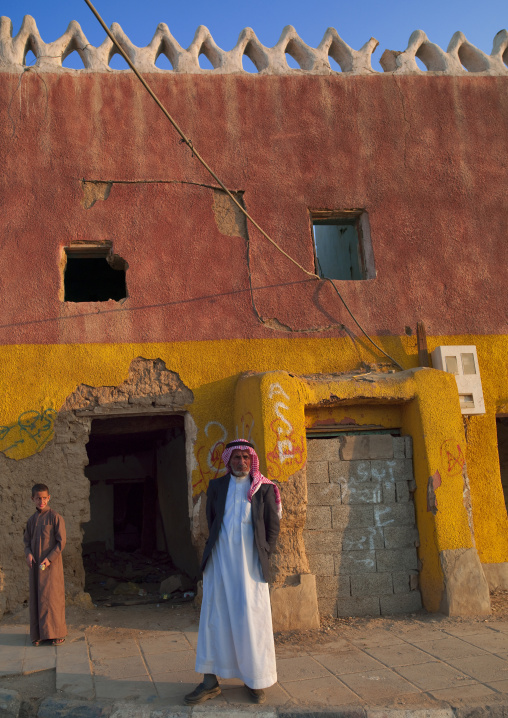 Saudi men in front of an old house, Najran Province, Najran, Saudi Arabia