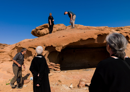 Western tourists visiting a qadeer sand stone castle, Al-Jawf Province, Sakakah, Saudi Arabia