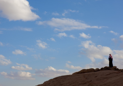 Saudi man on the top a hill, Al-Jawf Province, Sakaka, Saudi Arabia