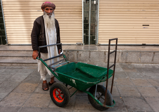 Old man with a long beard pushing a cart in the street, Makkah province, Taif, Saudi Arabia