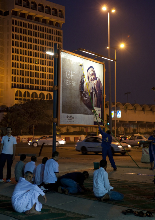 Men praying on the corniche at night, Mecca province, Jeddah, Saudi Arabia