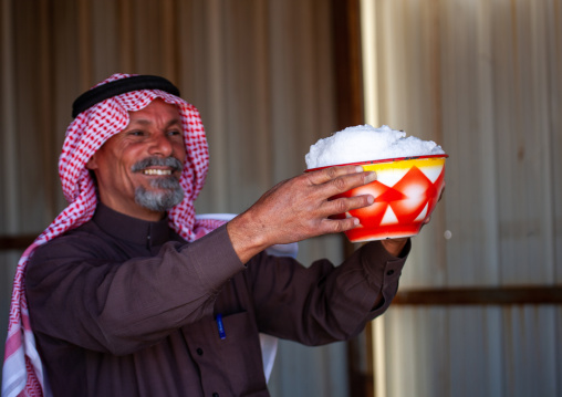 Saudi man offering fresh camel milk, Riyadh Province, Riyadh, Saudi Arabia