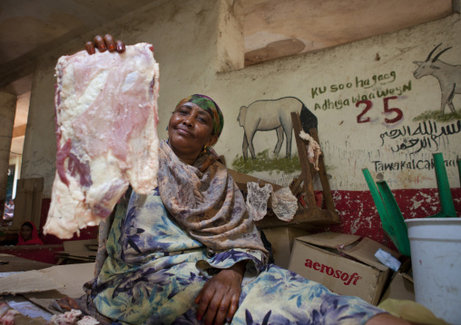 A Woman Meat Vendor Is Holding A Piece Of Livestock In Her Hand, Hargeisa, Somaliland