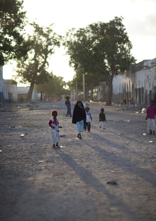 Children Playing In A Clay Ground Street At Sunset, Berbera, Somaliland