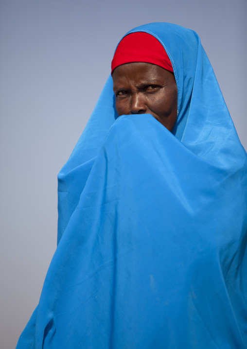 A Woman Wearing A Blue Hijab Is Hiding Her Mouth In Her Hands, Burao, Somaliland
