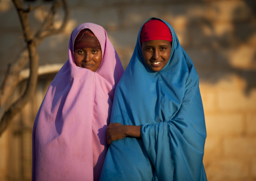 Two Cute Teenage Girls Wearing Colorful Dresses In The Declining Light, Baligubadle, Somaliland