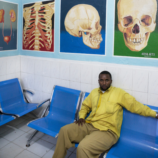 A Man In A Waiting Room With Organs Depicted Onto The Wall, Hargeisa, Somaliland