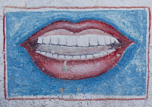 Dentist Advertisement Painted Sign Showing Mouth And Teeth On A Blue Background, Boorama, Somaliland