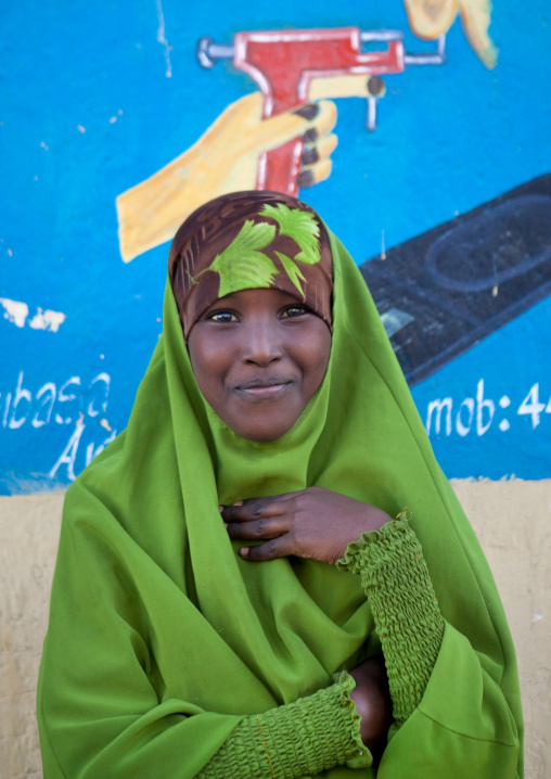 Portrait Of A Young Teenage Girl Wearing A Green Hijab In Front Of A Painted Wall, Boorama, Somaliland